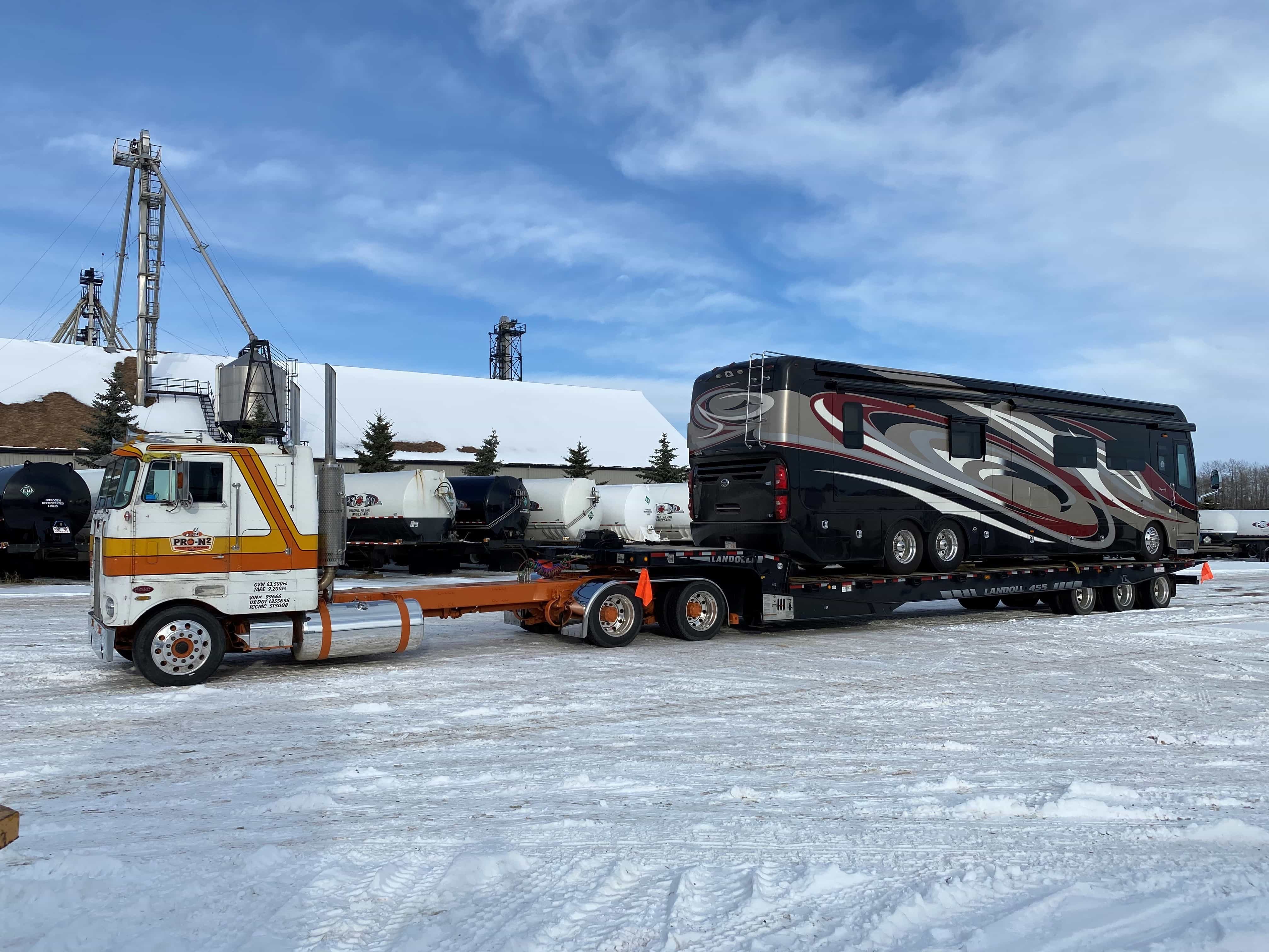 A ProN2 truck hauling an RV on a flatbed